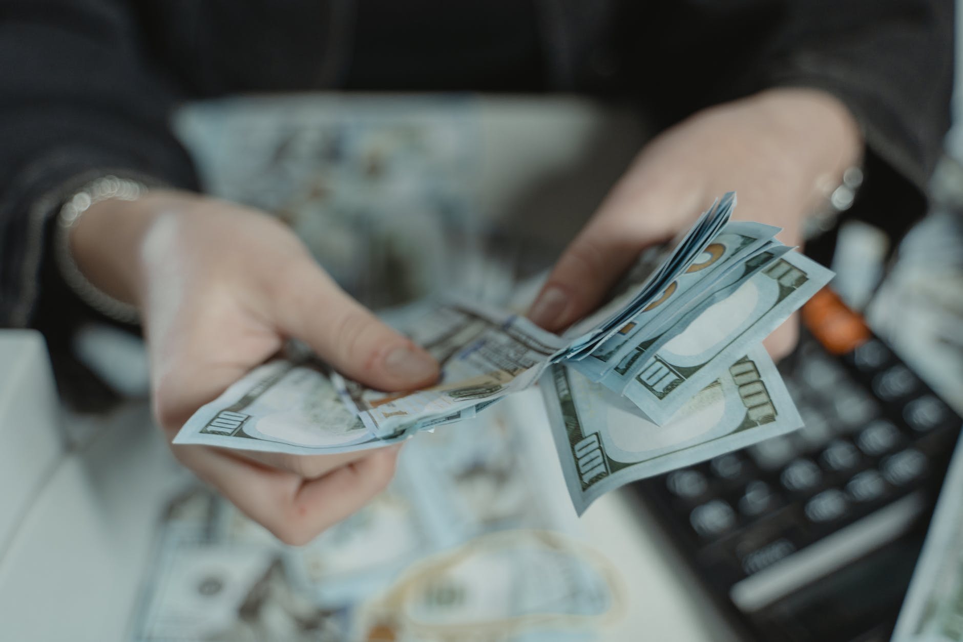 close up photo of a person counting bank notes