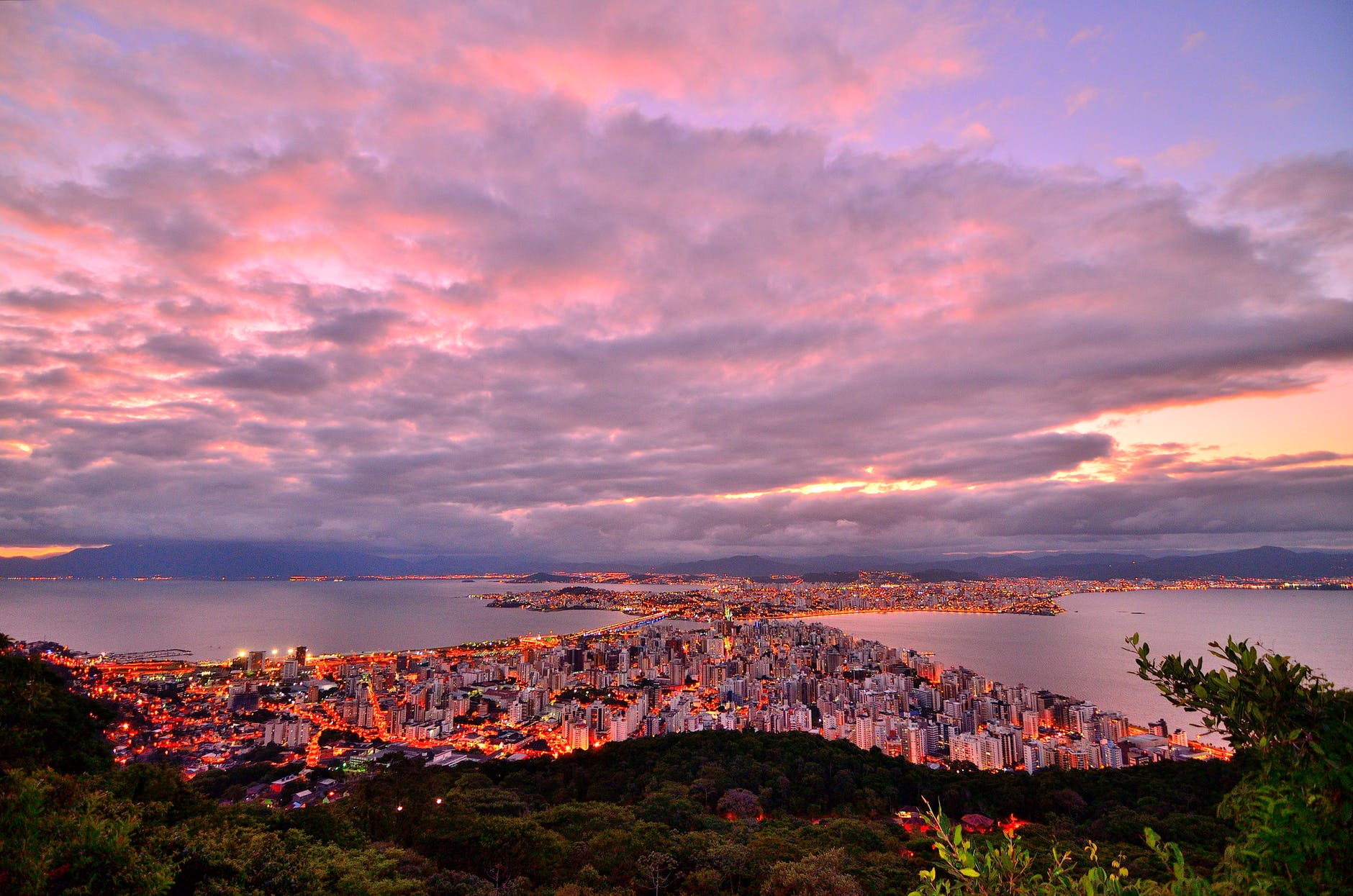 photo of city buildings taken up on the mountain during dusk