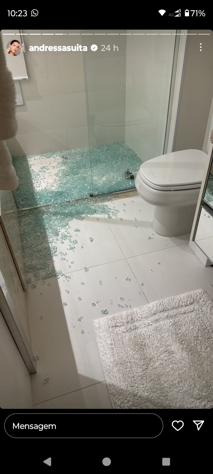 Banheiro com box de vidro quebrado no chão